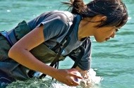 Cecilia Chung, BSc’10, MSc’13, gathering water samples from the Bow River in Banff National Park