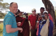 Dr. Frank van der Meer and student Eoin Clancy show Maasai herdsmen how to use the digital cameras. (Photo by Adam Thomas)
